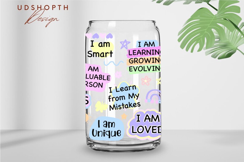 May include: A clear glass can with colorful stickers featuring positive affirmations like "I am Smart", "I am Unique", and "I am Loved".