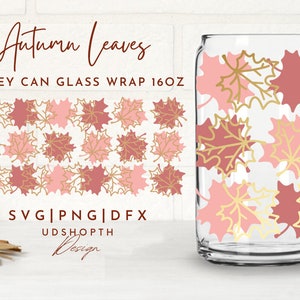 May include: A digital design for a 16 oz. Libbey can glass wrap featuring a pattern of pink and red maple leaves with gold outlines. The text "Autumn Leaves" is at the top of the design and the text "UDSHOPTH Design" is at the bottom.