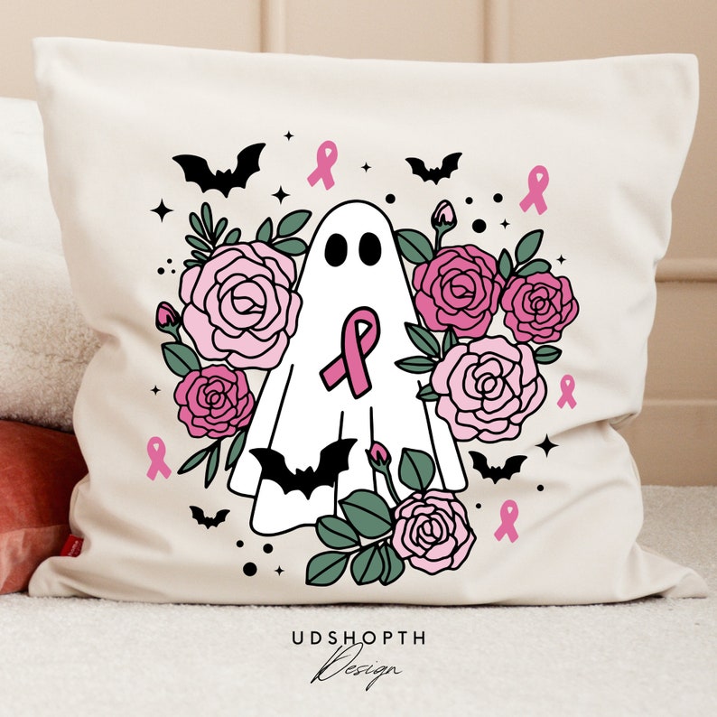 May include: A white pillow with a pink and black design featuring a ghost with a pink ribbon, bats, and roses. The text "UDSHOPTH Design" is at the bottom of the pillow.