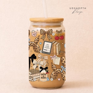 May include: A white ceramic mug with a black handle and the text "But First, Coffee" in a black, handwritten-style font. The mug is on a white surface.