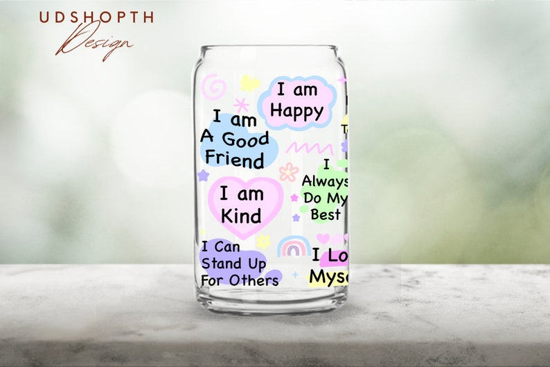 May include: A clear glass can with colorful text and illustrations. The text includes positive affirmations such as "I am a good friend", "I am kind", "I am happy", "I always do my best", "I can stand up for others", and "I love myself".