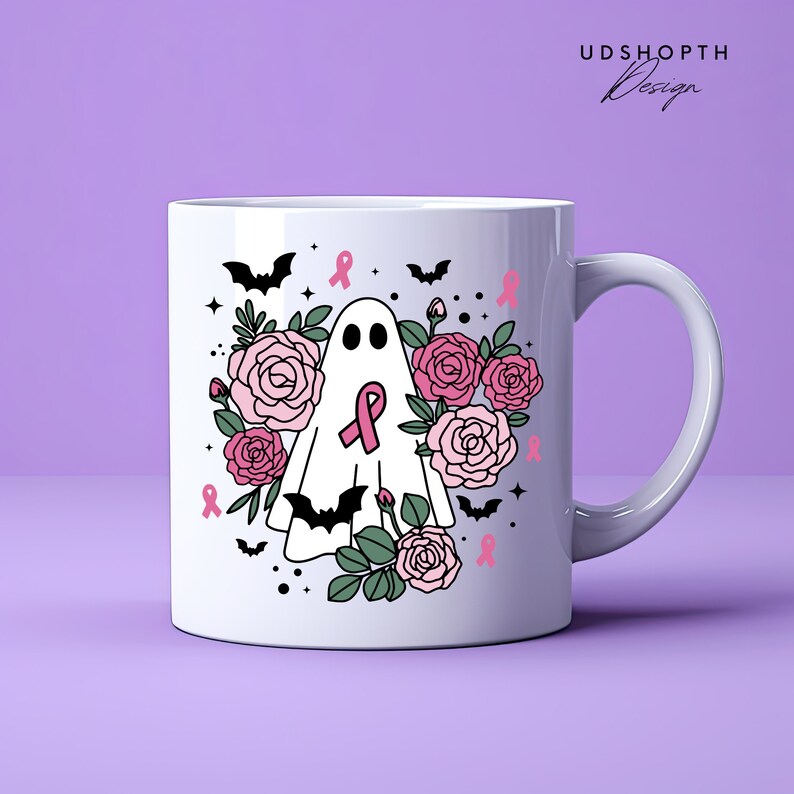 May include: White ceramic mug with a pink ribbon, ghost, bats, and roses design. The text "UDSHOPTH Design" is in the top right corner.