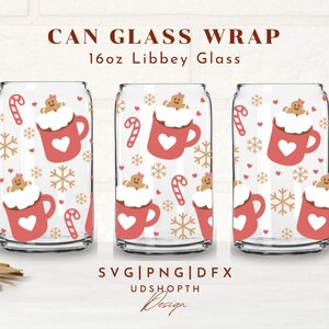May include: Three clear can glasses with a festive design. Each glass features a repeating pattern of a red mug with a heart, gingerbread person, candy cane, and snowflakes. The text "CAN GLASS WRAP" and "16oz Libbey Glass" is at the top.