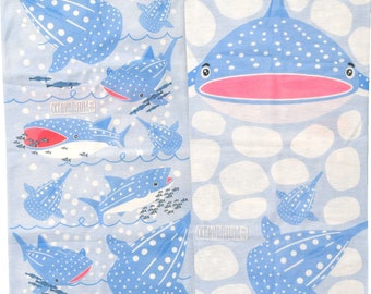 May include: A blue and white fabric with a repeating pattern of whale sharks. The whale sharks are swimming in a light blue ocean with white bubbles. The fabric has the text "Oceanarium" printed on it.