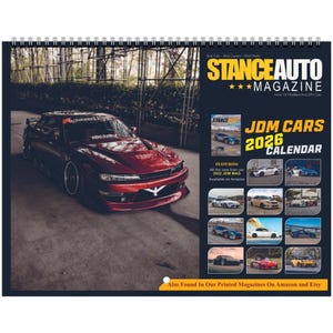 May include: A 2026 JDM Cars calendar featuring a red sports car on the cover. The calendar includes images of various modified JDM cars. The Stance Auto Magazine logo is visible, along with text that reads "Also Found In Our Printed Magazines On Amazon and Etsy."