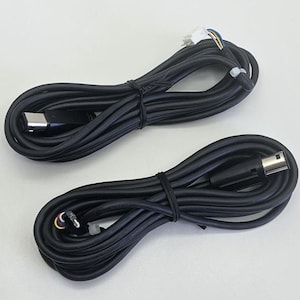 May include: Two black electrical cables with connectors at each end. The cables are coiled and secured with black rubber bands. One cable has a USB-C connector, and the other has a mini-USB connector.