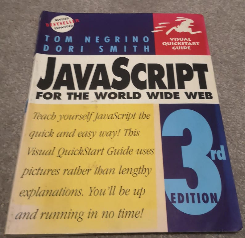 May include: A book titled "JavaScript for the World Wide Web" by Tom Negrino and Dori Smith. The cover features the title in large black letters, with "Visual QuickStart Guide" and "3rd Edition" also displayed. The book is a revised bestseller.