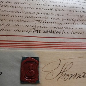May include: A detailed view of an old document with elegant handwriting and a red wax seal. The seal, set on a blue-green fabric, depicts a portrait. Red stripes and the word "witness" are visible.