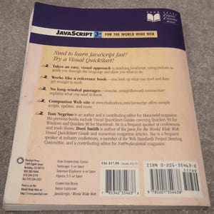 May include: The rear cover of a JavaScript programming book. The title reads "JavaScript 3rd Edition for the World Wide Web." The cover includes text about the book's features and author information. The book is published by Peachpit Press.