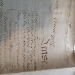 May include: An antique document with handwritten text, featuring the word "Counterpart" in ornate script. The aged paper shows faded ink and detailed script, with dates and legal terms visible. The document appears to be a legal or historical record.