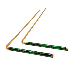 May include: Two gold-colored metal rods with green and black patterned handles. The rods are bent at a 90-degree angle.