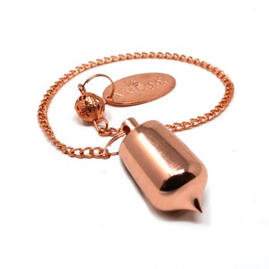 May include: A copper pendulum with a pointed tip, a small ball, and a chain. The pendulum is attached to a small oval tag with the word "MYD88" engraved on it.