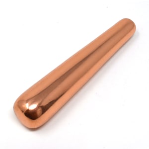 May include: A smooth, copper-colored massage tool shaped like a long, rounded cylinder.