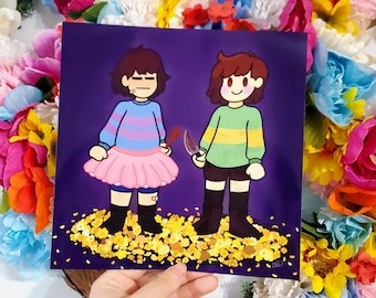 May include: Square print featuring two cartoon characters on a purple background. One character wears a blue and pink striped sweater and a pink skirt, the other wears a green and yellow sweater and holds a knife. The print is held in front of a floral wreath.