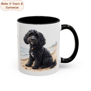 May include: White ceramic mug with a black interior and handle. The mug features a watercolor illustration of a black dog sitting on a sandy beach. The text "Make it Yours & Customize" is in the upper left corner.