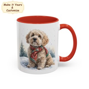 May include: A white ceramic mug with a red interior and handle. The mug displays a watercolour illustration of a fluffy, light brown dog wearing a red and green scarf, set in a snowy scene. Text on the top left says "Make it Yours & Customize".