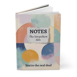 May include: A hardcover notebook with a colorful abstract design. The cover features a collage of pastel colors, including blue, orange, and yellow. The text "NOTES The Unspoken Bits" is displayed on a textured paper, with the phrase "You're the real deal" at the bottom.