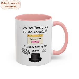 May include: White ceramic coffee mug with a pink rim and handle. The mug has a humorous design with the text "How to Beat Me at Monopoly?" and a computer error message that says "System error 404".