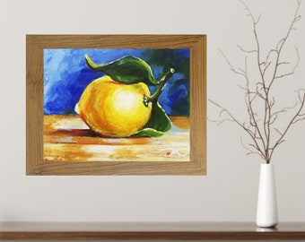 May include: A framed painting of a single lemon with green leaves on a wooden surface against a blue background.