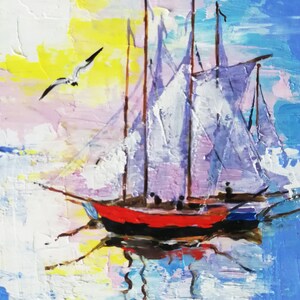 May include: A painting of a red and black sailboat with white sails against a blue and pink sky. The sailboat is in the water with a seagull flying overhead.