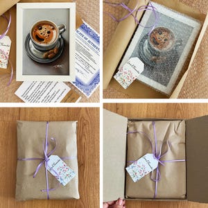 May include: A framed artwork of a coffee cup with a detailed drawing of the coffee and saucer. The artwork is packaged in brown paper with a purple ribbon and a "Loved Thanks" tag. A certificate of authenticity is also included.