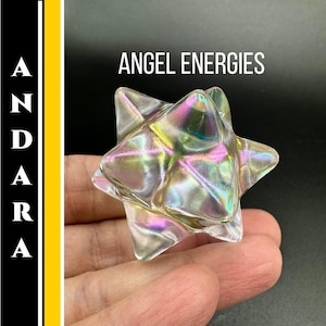 May include: A clear, multi-faceted star-shaped crystal with iridescent colors of pink, yellow, and green. The text "ANGEL ENERGIES" is above the crystal. The word "ANDARA" is written vertically on the left side of the image.