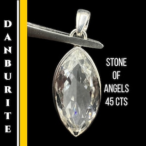 May include: A clear, marquise-cut Danburite pendant held by tweezers. The pendant is labeled "Stone of Angels" and is 45 carats. The background is black with a yellow vertical stripe and the word "Danburite" in white.
