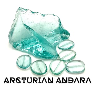 May include: An assortment of aqua-coloured glass pieces, featuring a large, irregularly shaped chunk and several smaller, oval-shaped beads. The text "ARCTURIAN ANDARA" is displayed in a bold, black font at the bottom of the image.