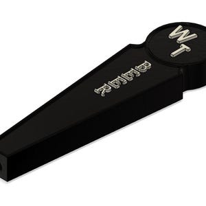 May include: Black bottle opener with a silver inscription that reads "remarkable" and a round black cap with the letters "WT" in silver.