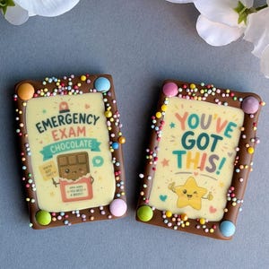 May include: Two rectangular chocolate treats with colourful sprinkles and a chocolate frame. One says "Emergency Exam Chocolate" with a chocolate bar graphic. The other says "You've Got This!" with a star graphic. Both have colourful candy accents.