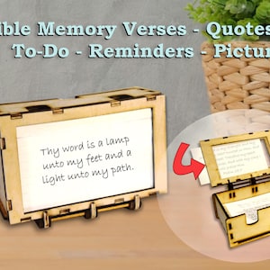 May include: A wooden box with a rectangular frame displaying a white card inscribed with "Thy word is a lamp unto my feet and a light unto my path." The box is open, showing more cards. The text "Bible Memory Verses - Quotes - To-Do - Reminders - Pictures" is at the top.