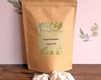 May include: A brown paper bag with a white label that says "Starch House" and "Carpet Freshener Lemon Fresh". The bag is open and a white powder is spilling out. A wooden scoop is next to the powder.