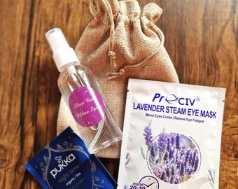 May include: A set of self-care products including a lavender steam eye mask, a bottle of sleep pillow spray, and a blue tea bag with the text "Pukka night time organic/bio nuit paisible".
