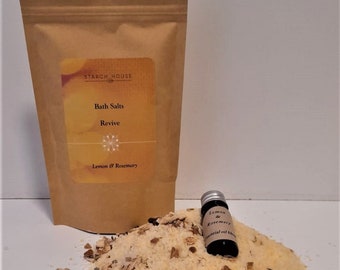 May include: A brown paper bag with a label that reads "Starch House Bath Salts Revive Lemon & Rosemary" and a small bottle of lemon and rosemary essential oil.