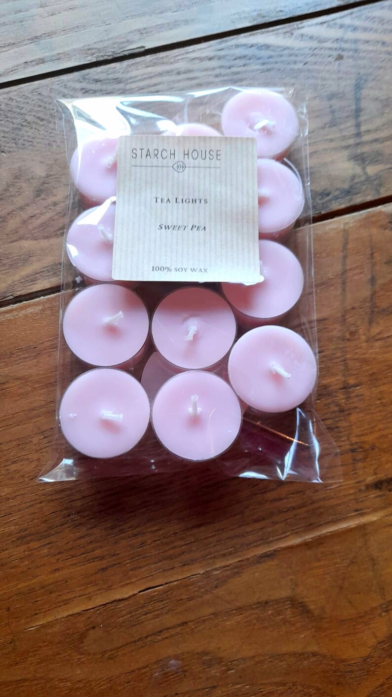 May include: A package of pink tea lights with a label that reads "Starch House" and "Tea Lights Sweet Pea 100% Soy Wax".