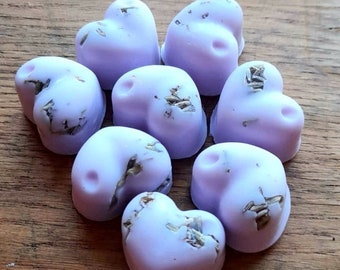 May include: Eight lavender-colored heart-shaped wax melts with dried flowers embedded in the wax.