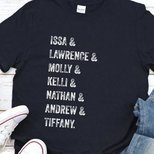 May include: Black t-shirt with white text that reads "ISSA & LAWRENCE & MOLLY & KELLI & NATHAN & ANDREW & TIFFANY."