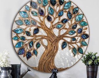 May include: A round wall art piece featuring a golden tree design with blue and teal crystal leaves. The tree is set against a white, textured background. The artwork is displayed above a white dresser with a black dog statue and potted plants.