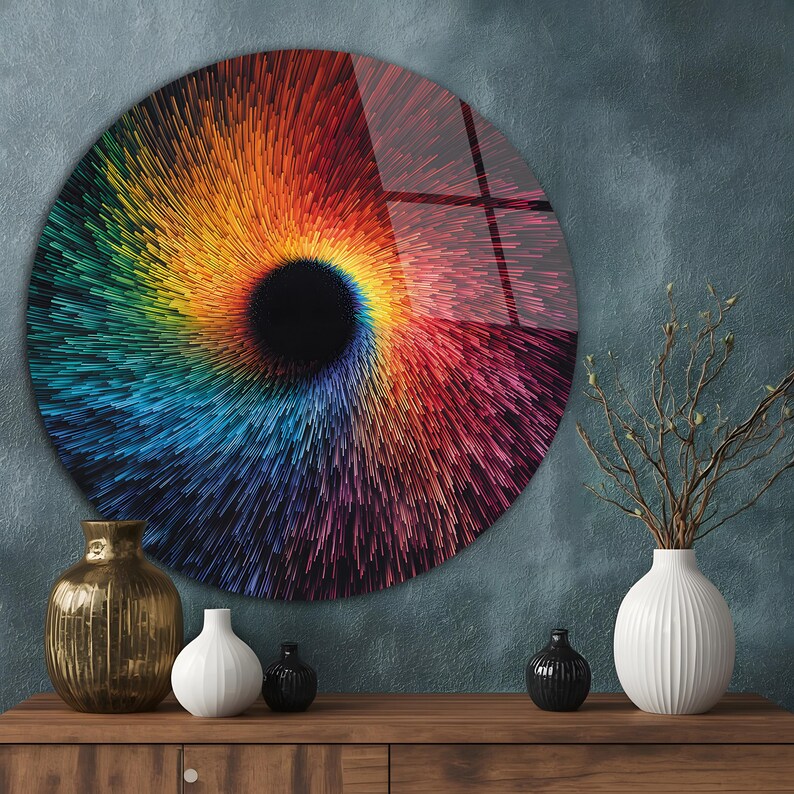May include: A round wall art piece with a vibrant, swirling design in a spectrum of colors, from red and orange to blue and green. The artwork has a central black void, creating a dynamic, eye-catching visual effect. The art piece is displayed on a wall.