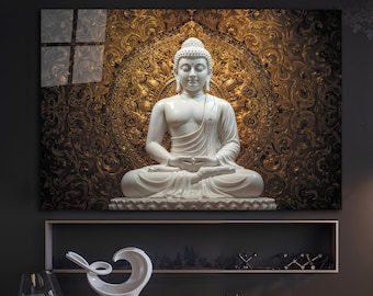 May include: A white Buddha statue in a seated meditation pose, set against a gold and brown patterned background. The artwork is framed and mounted on a dark wall. The statue is a focal point, exuding serenity and peace.