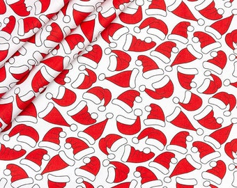 May include: White fabric with a repeating pattern of red Santa hats. The hats are outlined in black and have a white pom-pom on top.