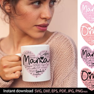 May include: A white ceramic mug with a pink heart design and the word "Mama" in the center, surrounded by German words. The mug is held by a person wearing a pink sweater. Additional pink heart designs are visible.