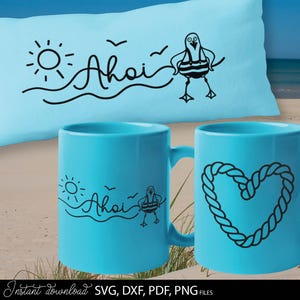 May include: A light blue pillow and two mugs with a nautical theme. The pillow has the word "Ahoi" with a sun, waves, and a seagull. One mug has the same design, and the other has a rope heart.