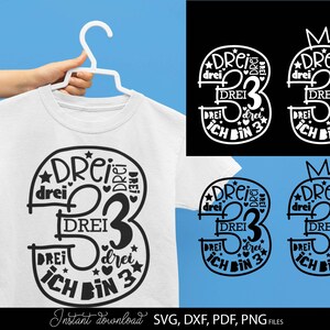 Peut inclure: Un design noir et blanc représentant le chiffre trois avec le mot "drei" (allemand pour trois) répété autour. Le design comprend également les mots "Ich bin 3" (allemand pour "J'ai 3 ans").