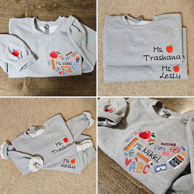 May include: Four grey sweatshirts with embroidered designs. One sweatshirt has a red apple and school supplies, another has the text "Ms. Trashana" and "Ms. Lesly", and the other two have the text "Ms. Trashana" and "Ms. Lesly" with a red apple.