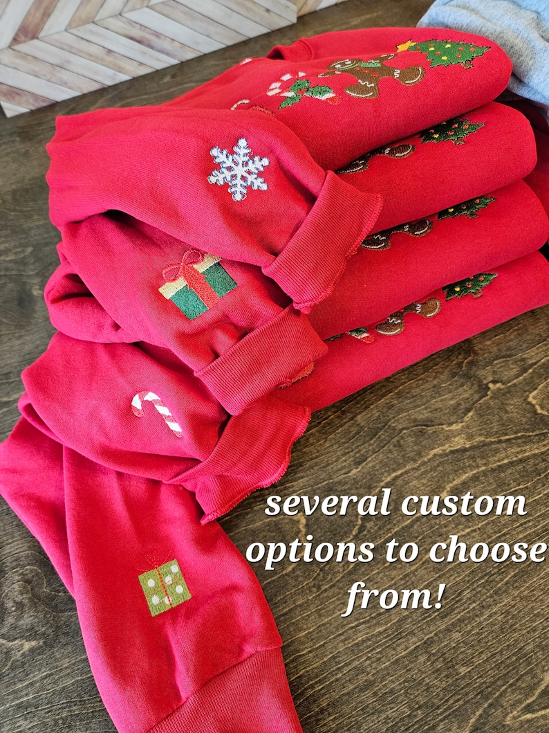 May include: A stack of red Christmas sweaters with various embroidered designs, including snowflakes, candy canes, and gift boxes. The text "several custom options to choose from!" is visible in the image.