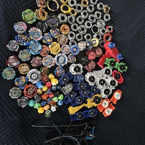 Beyblade Collectible toys mixed lot of tops, forge discs etc