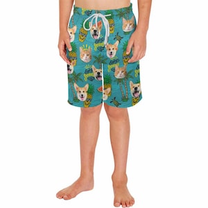 May include: A pair of blue swim trunks with a tropical print featuring pineapples, palm trees, and dogs. The print includes the text "Enjoy Summer".