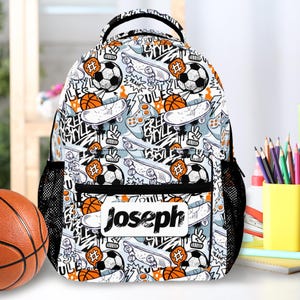 May include: A personalised backpack featuring a pattern of skateboards, basketballs, footballs, and game controllers on a white background. The name "Joseph" is printed on a white label. The backpack has black mesh side pockets.