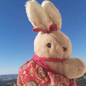 Vintage plush bunny girl. Italian vintage Plush bunny in red floral dress. Plush bunny vintage Italy